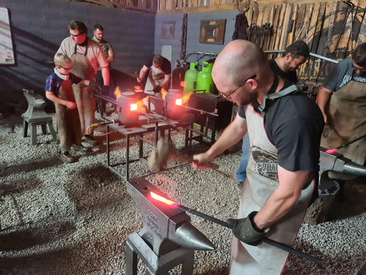 Why Your Next Team Building Event Should Involve Fire, Steel, and Sweat