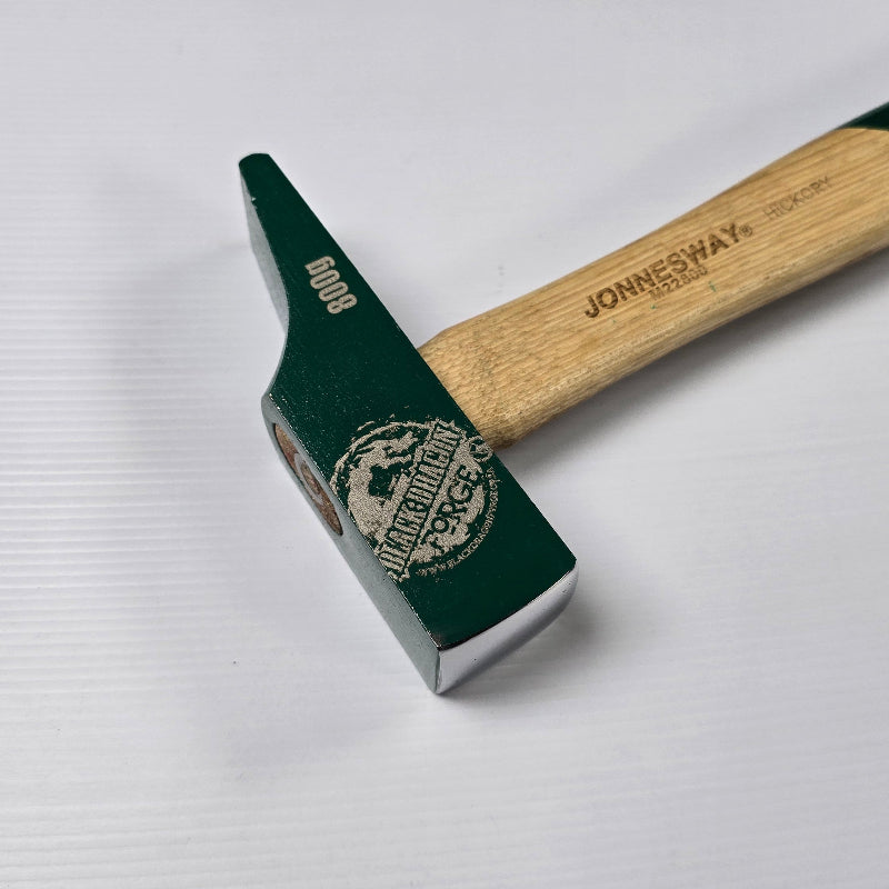 Green hammer with wooden handle on a white background