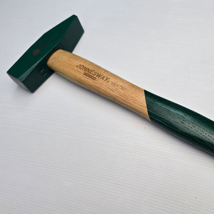A green forging hammer with a wooden handle and a steel head, featuring a cross peen design.