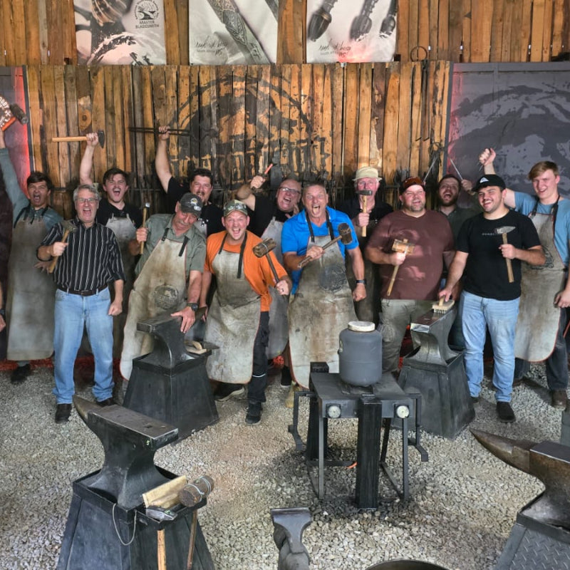 Black Dragon Forge Bladesmithing Experience  - Group of people in a blacksmith workshop with an anvil and tools.