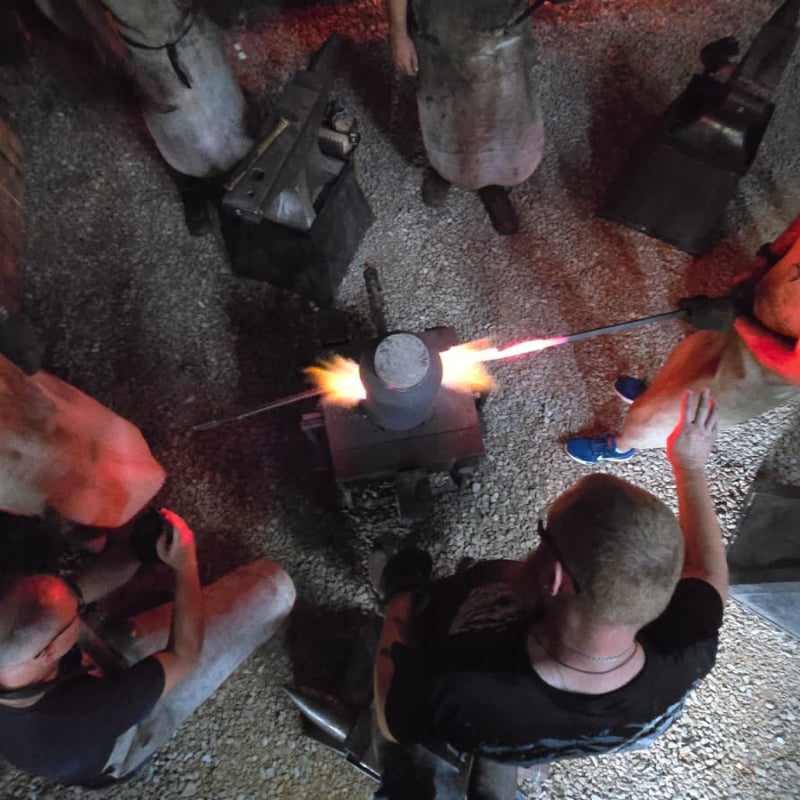 Students working with hot metal during the Black Dragon Forge Bladesmithing Experience 