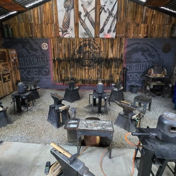 Black Dragon Forge Workshop with various tools and equipment on wooden walls and floors.