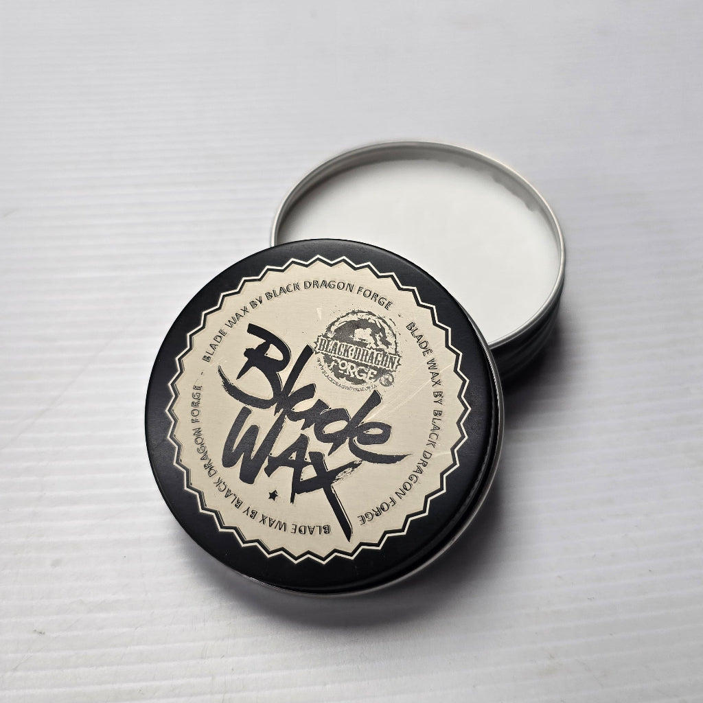 Black wax container with lid on a gray background