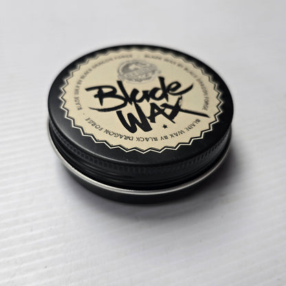 Round container of Blade Wax on a white background