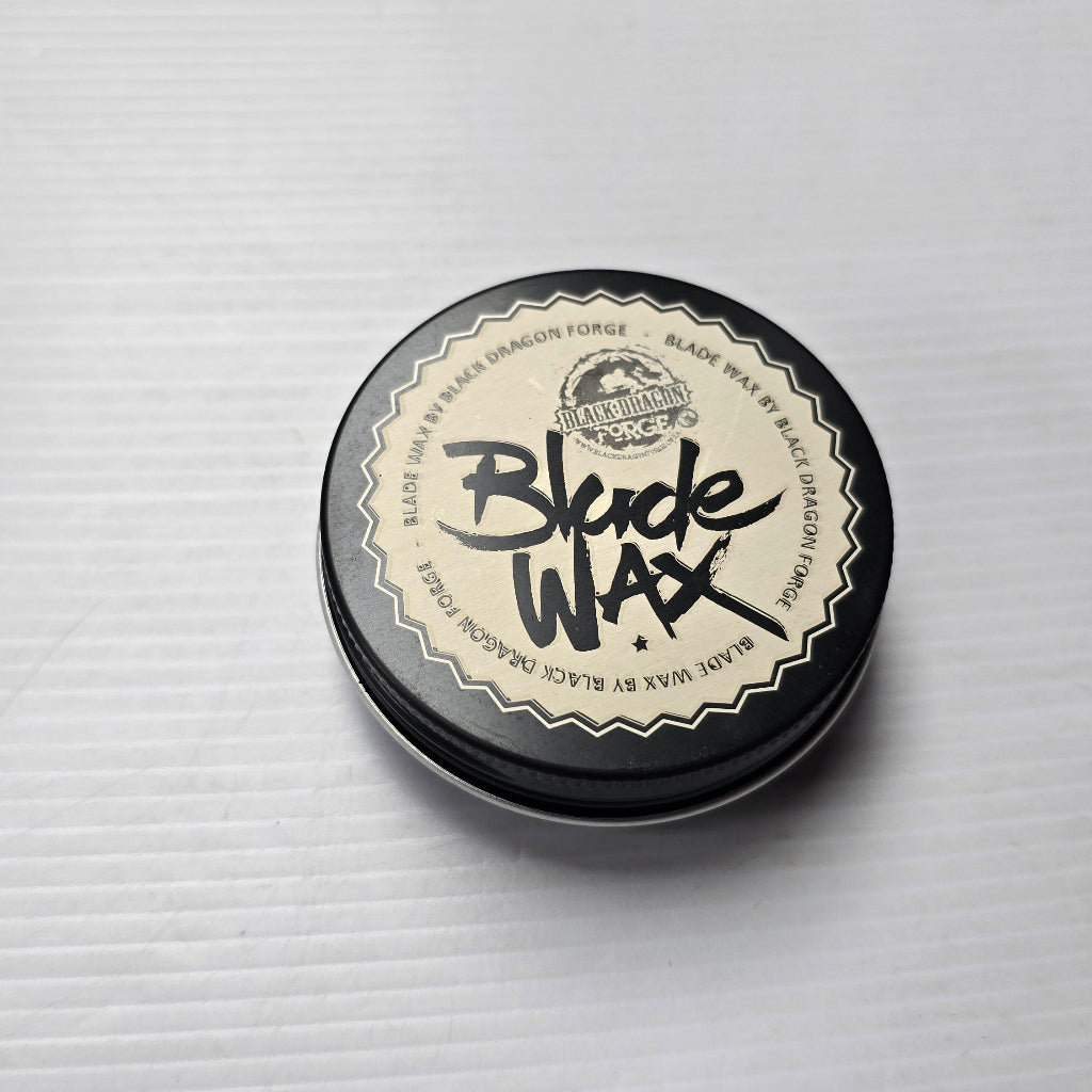 Round container of Blade Wax on a light gray background