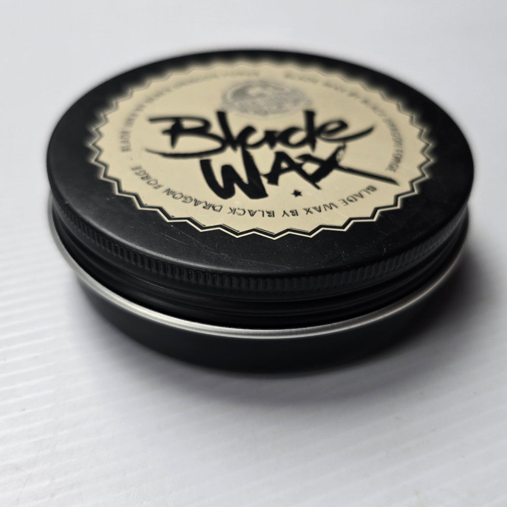 Black wax container with lid on a white background