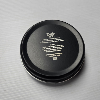 Black round container with text on a gray background
