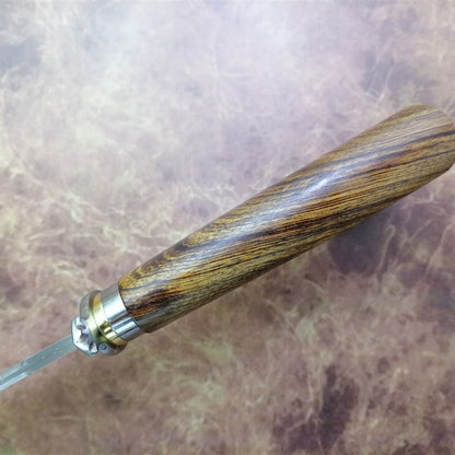Wooden-handled knife on a textured surface