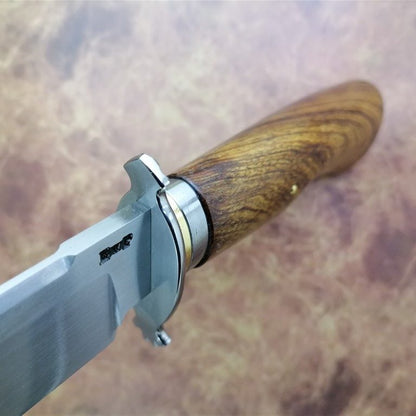 Knife with a wooden handle on a blurred background