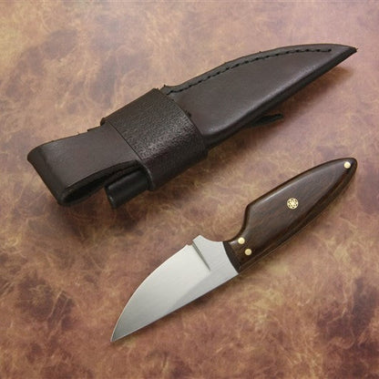 Knife with wooden handle and leather sheath on a brown textured surface
