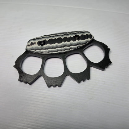Black metal knuckle duster on a white background