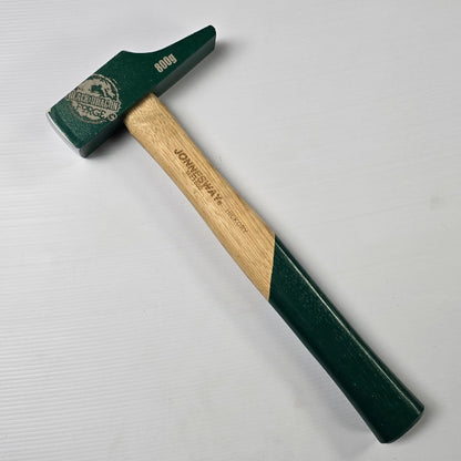 Hammer with green head and wooden handle on a white background