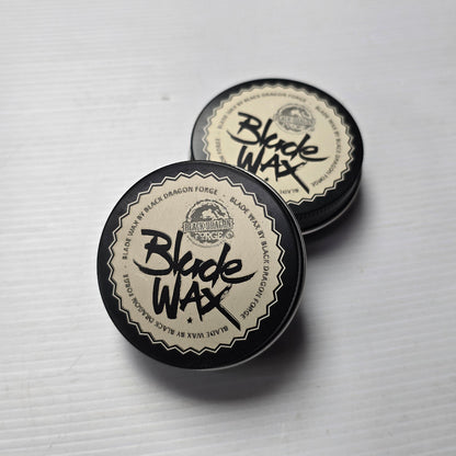 Two containers of Black Wax on a light gray background