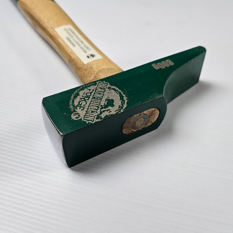 Green hammer with wooden handle on a white background