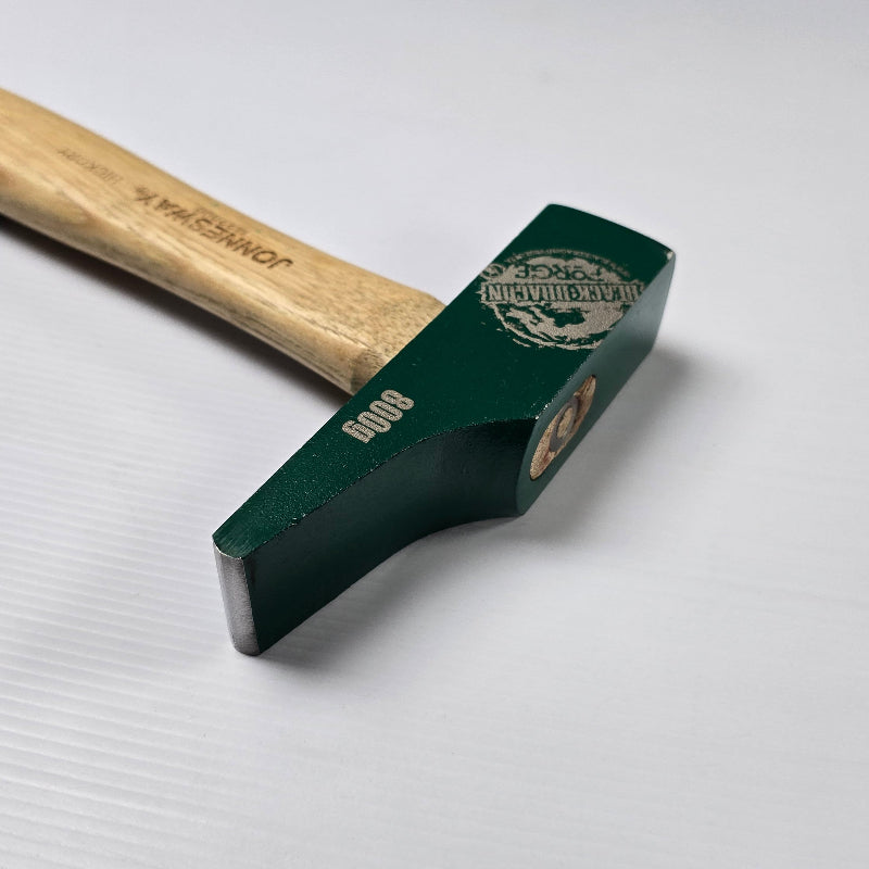 Green hammer with wooden handle on a white background