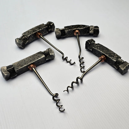 Set of four metal corkscrews on a white background